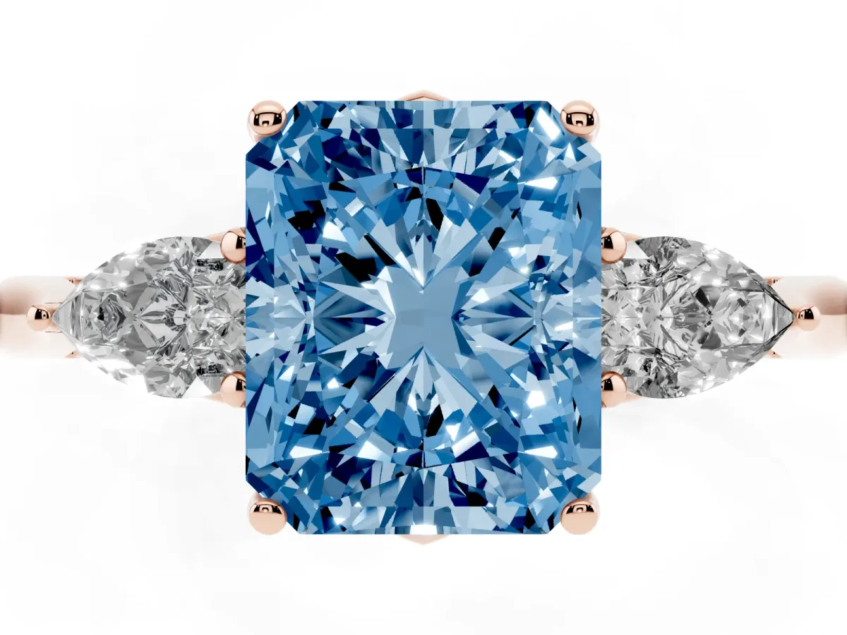 Fancy Blue Three-Stone Radiant Cut Diamond Ring with Pear Side Stones in Four-Prong Setting Rose gold