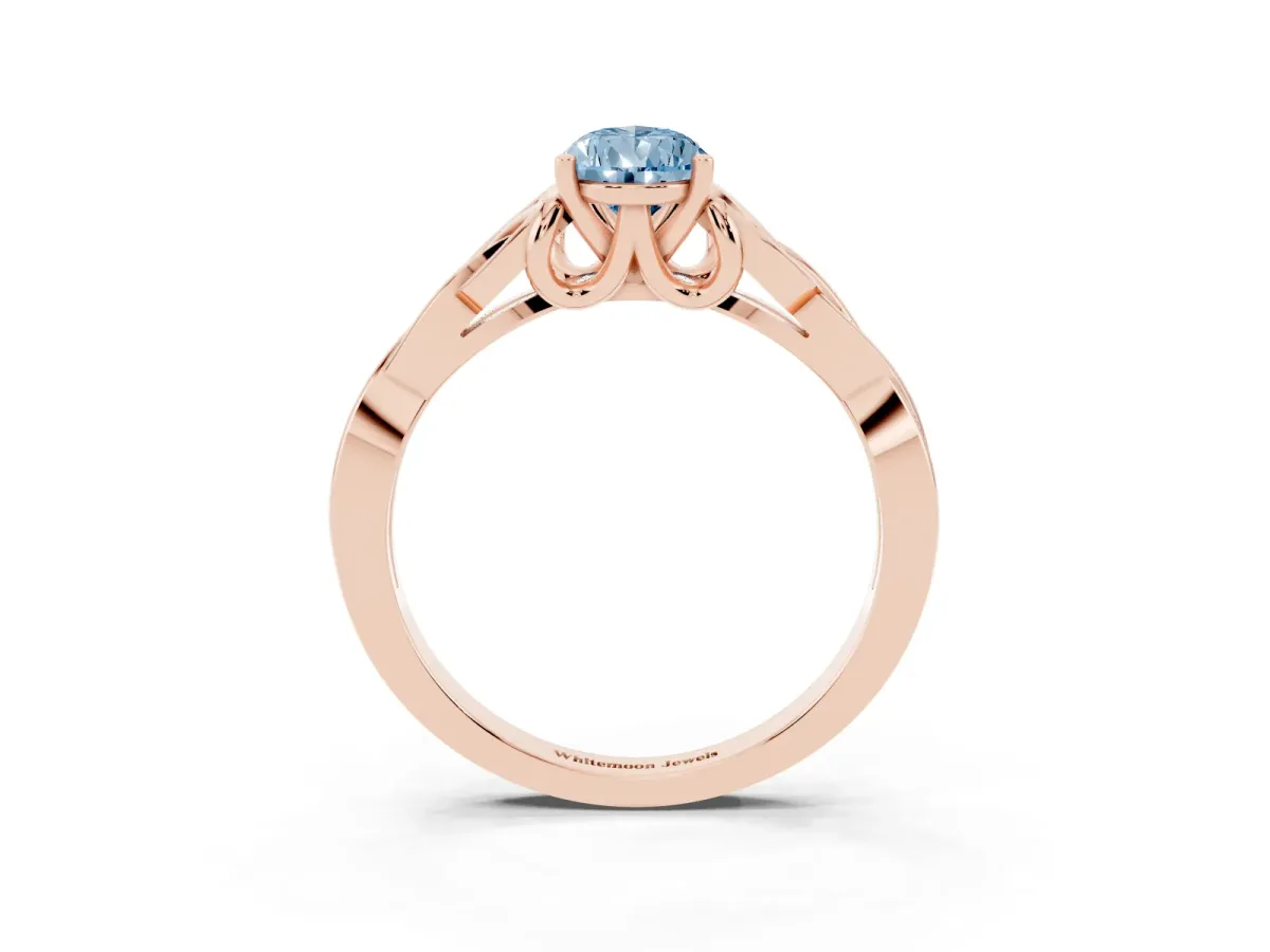 Fancy Blue Pear Cut Diamond Solitaire Engagement Ring with Celtic Knot Band and Four-Prong Setting Rose gold