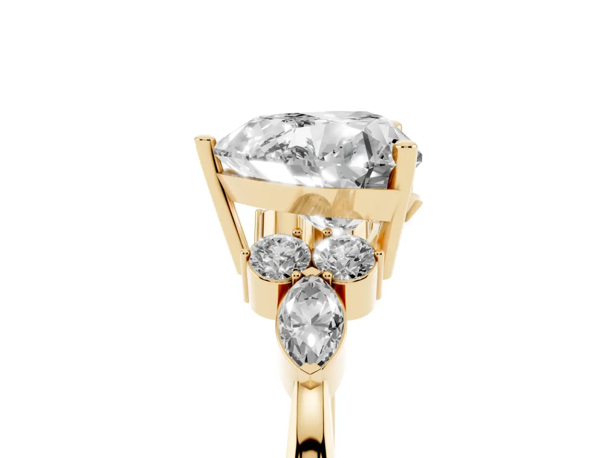 Heart Cut Brilliant Diamond Solitaire Ring with Pear Side Stones and Four-Prong Setting Yellow gold