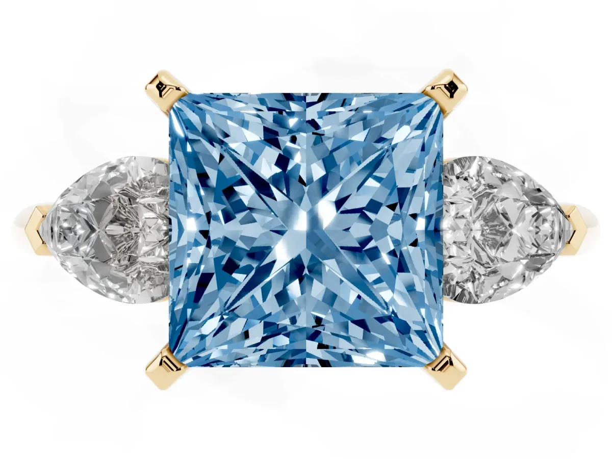 Fancy Blue Three-Stone Princess Cut Diamond Ring with Pear Side Stones and Four-Prong Setting Yellow gold