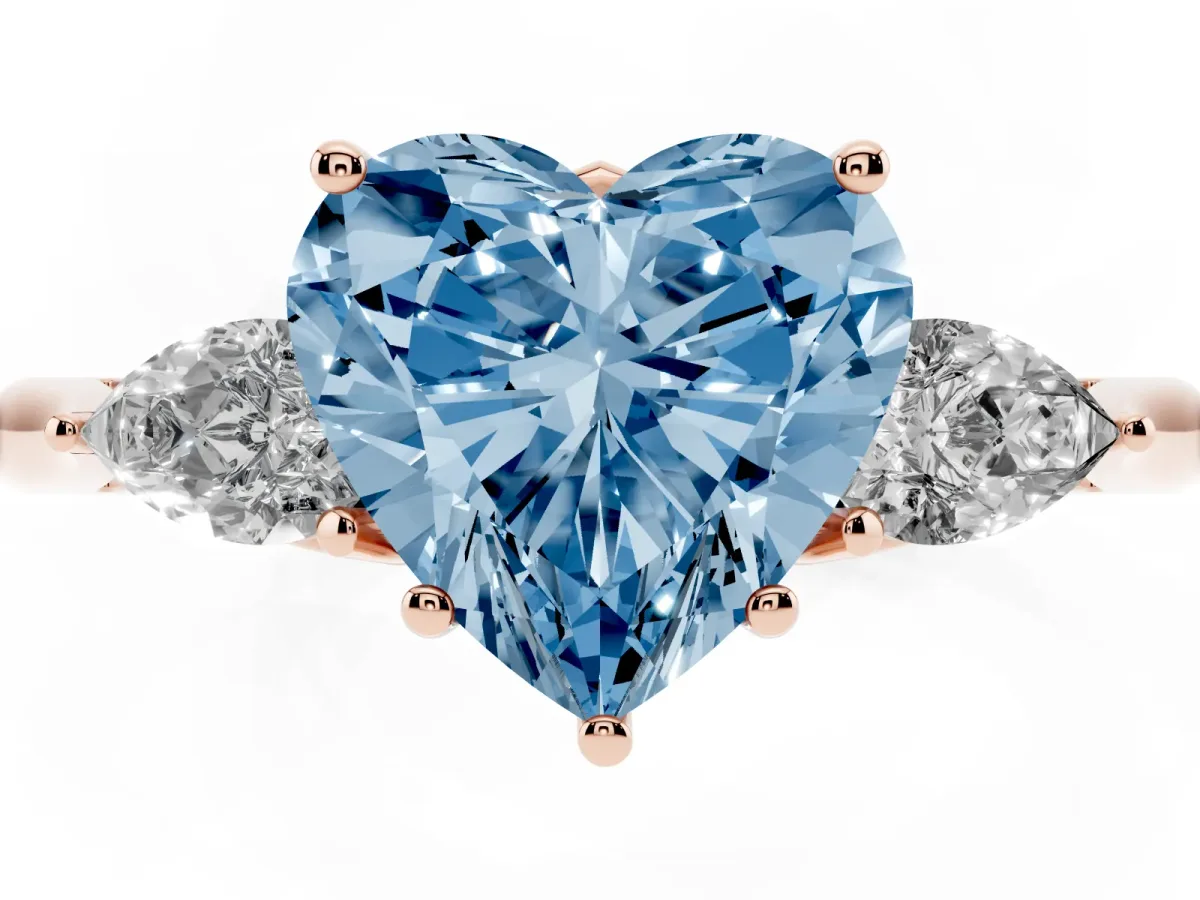 Fancy Blue Three-Stone Heart Cut Brilliant Diamond Solitaire Ring with Tapered Band and Four-Prong Setting Rose gold