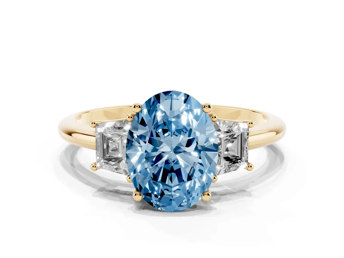 Fancy Blue Oval Cut Diamond Three-Stone Ring with Trapezoid Side Stones and Prong Setting Yellow gold