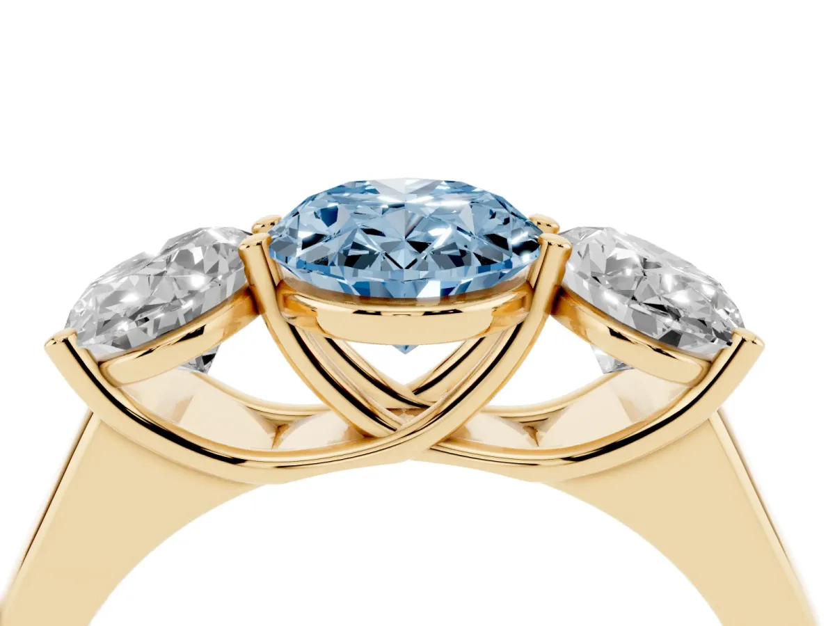 Fancy Blue Oval Cut Three-Stone Diamond Ring with Prong Setting on a Classic Band Yellow gold