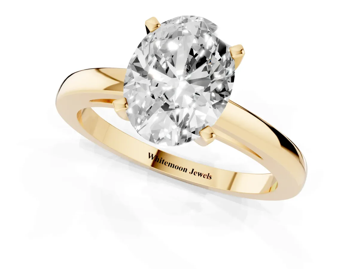 Oval Cut Solitaire Diamond Engagement Ring with Four-Prong Setting on a Classic Band Yellow gold