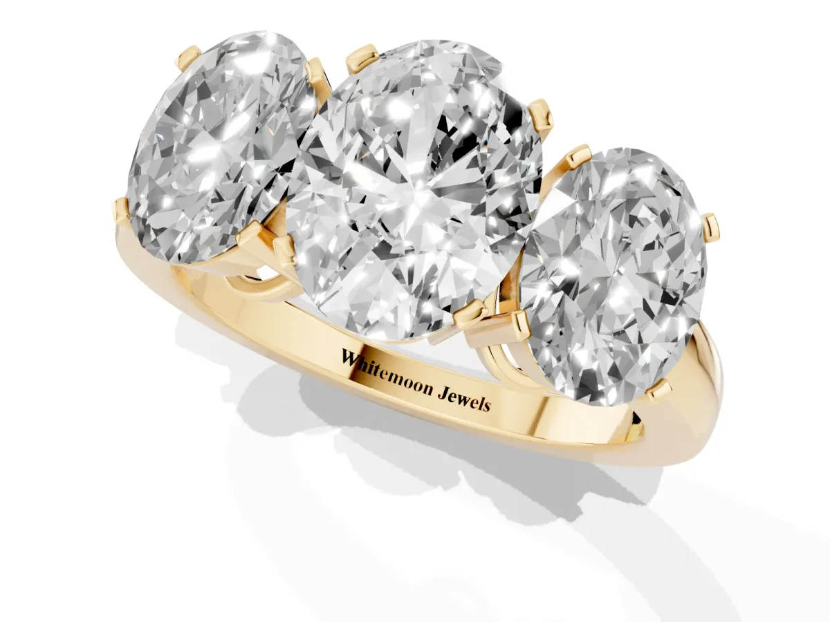 Three-Stone Oval Cut Cut Diamond Ring with Channel Set Band and Four-Prong Setting Yellow gold
