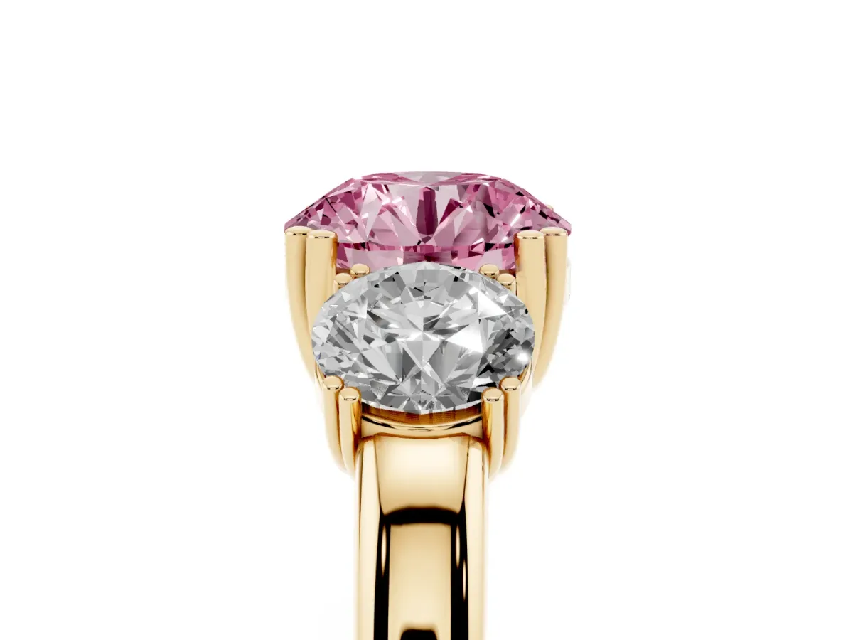 Fancy Pink Three-Stone Round Cut Cut Diamond Ring with Channel Set Band and Four-Prong Setting Yellow gold