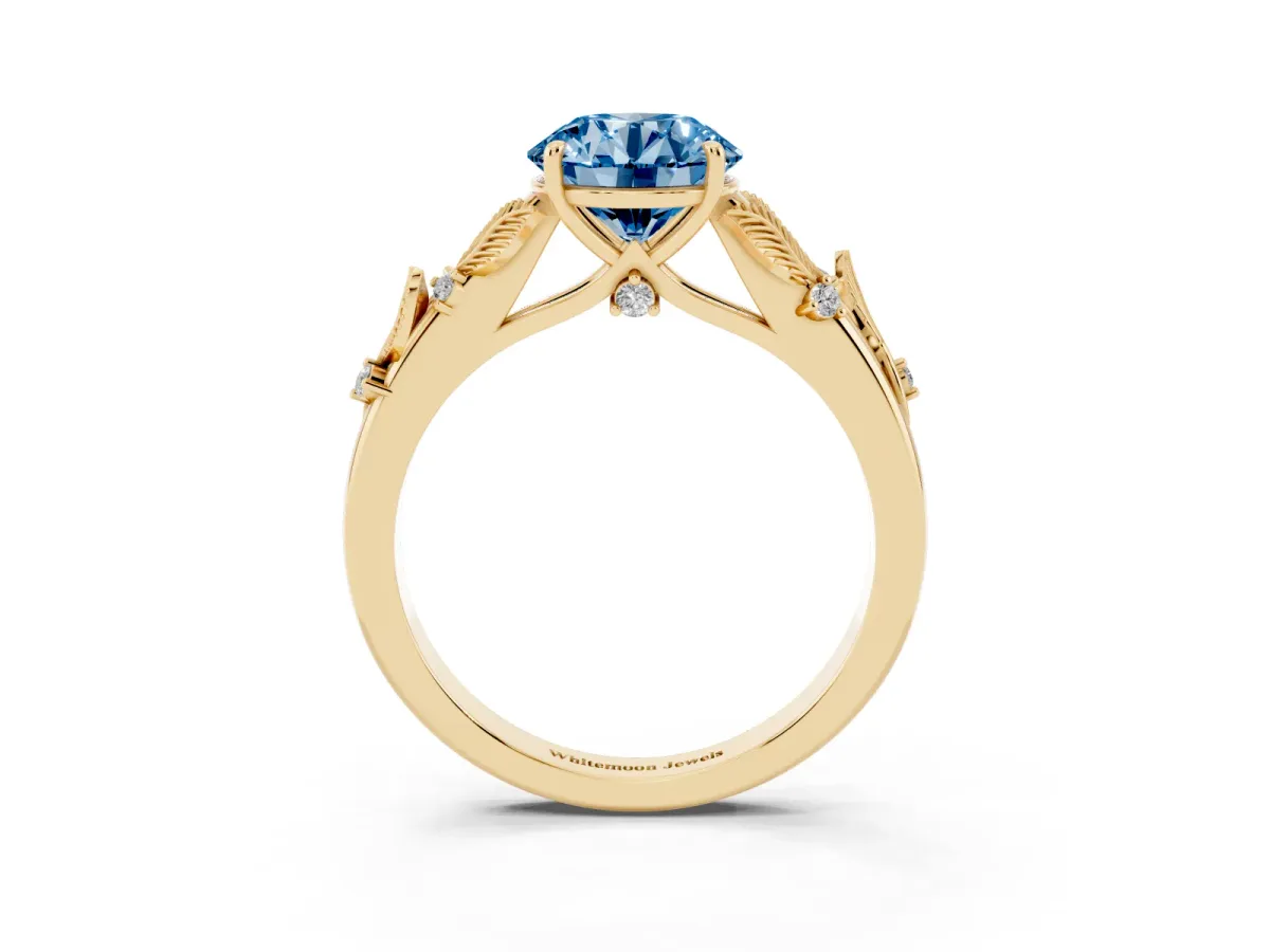 Fancy Blue Round Cut Diamond Solitaire Ring with Leaf Motif Band and Four-Prong Setting Yellow gold