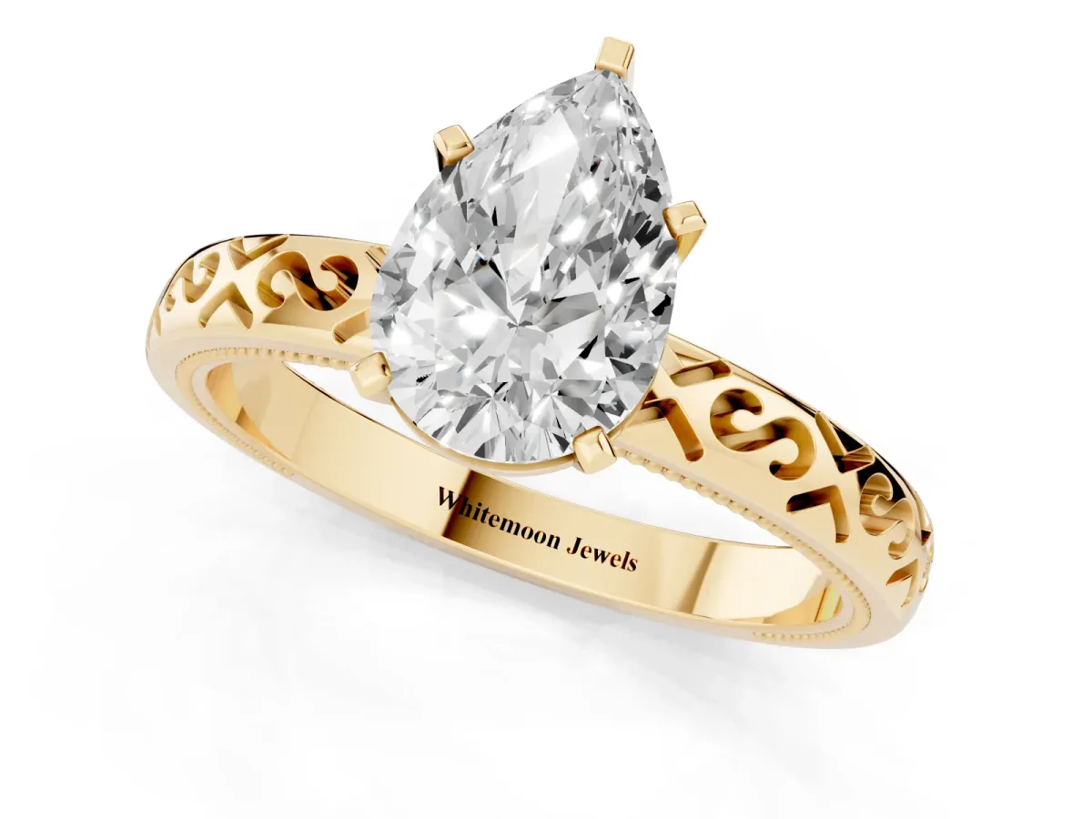 Pear Cut Solitaire Engagement Ring with Scrollwork Band and Four-Prong Setting Yellow gold