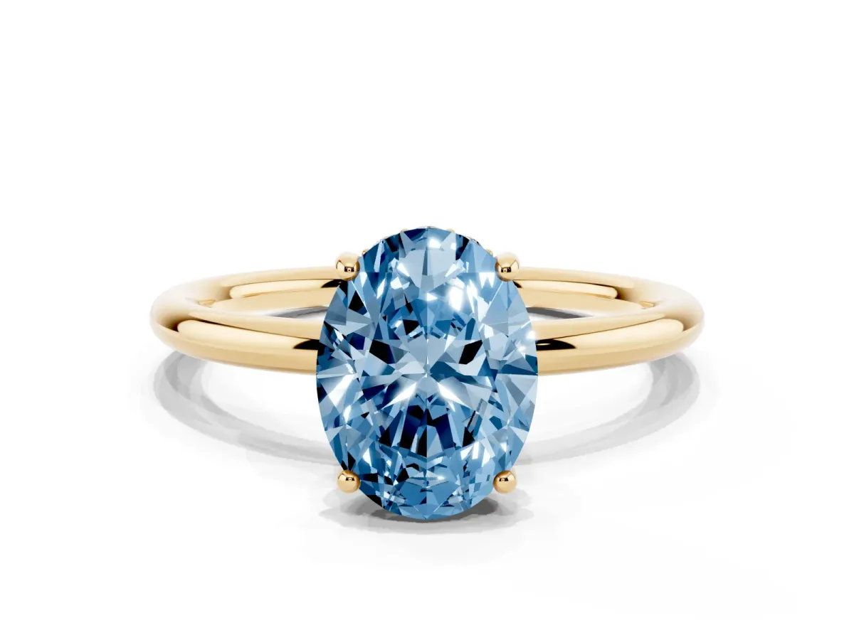 Fancy Blue Oval Cut Solitaire Diamond Ring with a Classic Band and Four-Prong Setting Yellow gold