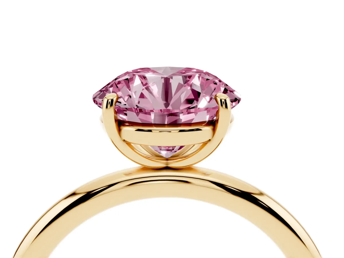 Fancy Pink Round Cut Solitaire Diamond Ring with Four-Prong Setting on a Plain Band Yellow gold