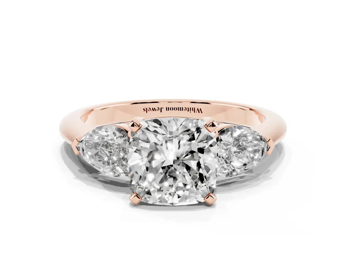 Three-Stone Cushion Cut Diamond Ring with Pear Side Stones and Four-Prong Setting Rose gold