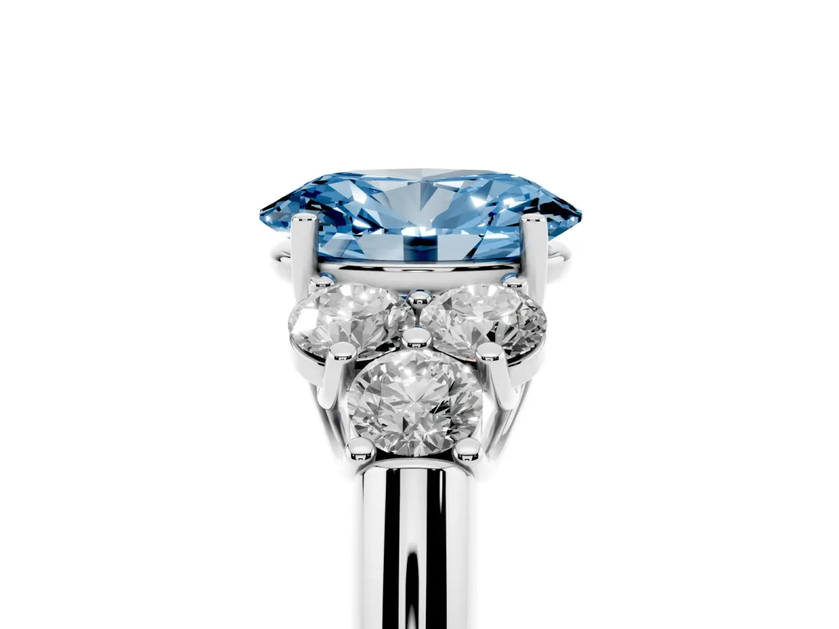 Fancy Blue Oval Cut Cut Diamond Cluster Ring with Round Accent Stones and Prong Setting on a Classic Band Silver