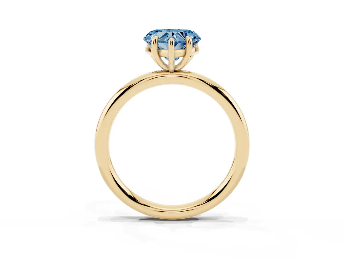 Fancy Blue Heart Cut Solitaire Diamond Ring with Four-Prong Setting on a Plain Band Yellow gold