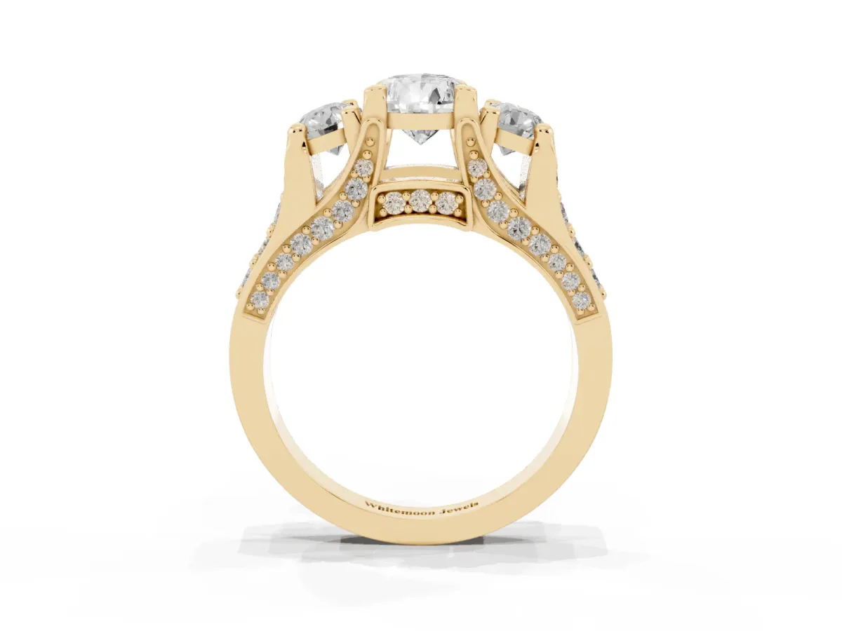 Pear Cut Diamond Three-Stone Ring with Channel Set Band and Four-Prong Setting Yellow gold