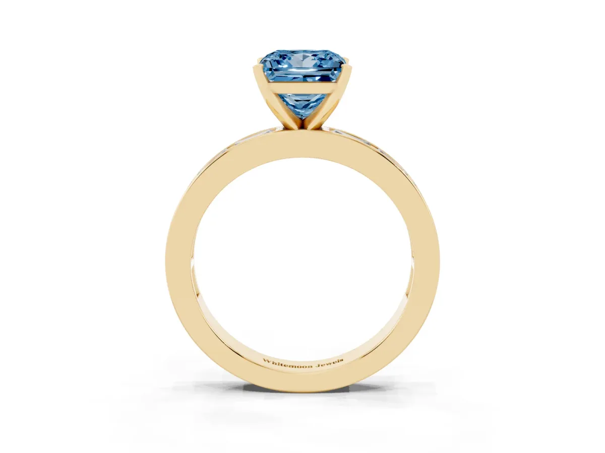 Fancy Blue Princess Cut Solitaire Diamond Ring with Channel-Set Baguette Band and Four-Prong Setting Yellow gold