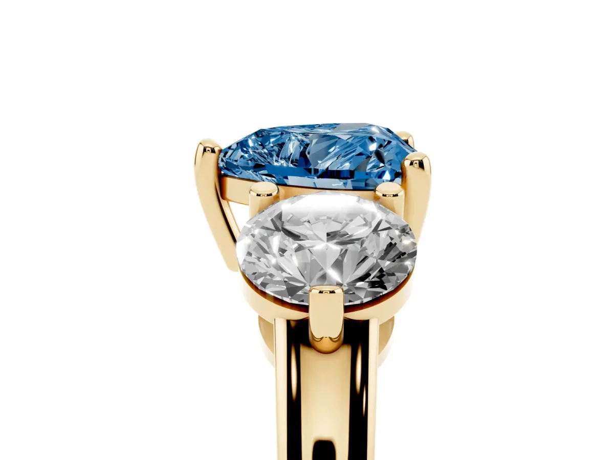 Fancy Blue Three-Stone Heart Cut Brilliant Cut Solitaire Ring with Prong Setting on a Classic Band Yellow gold