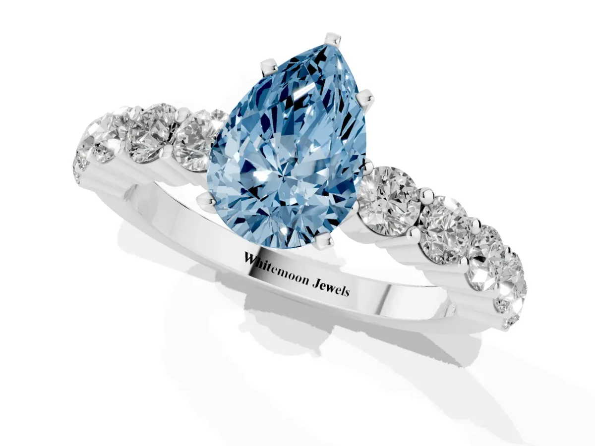 Fancy Blue Pear Cut Diamond Solitaire Ring with Shared Prong Round Side Stones Platinum