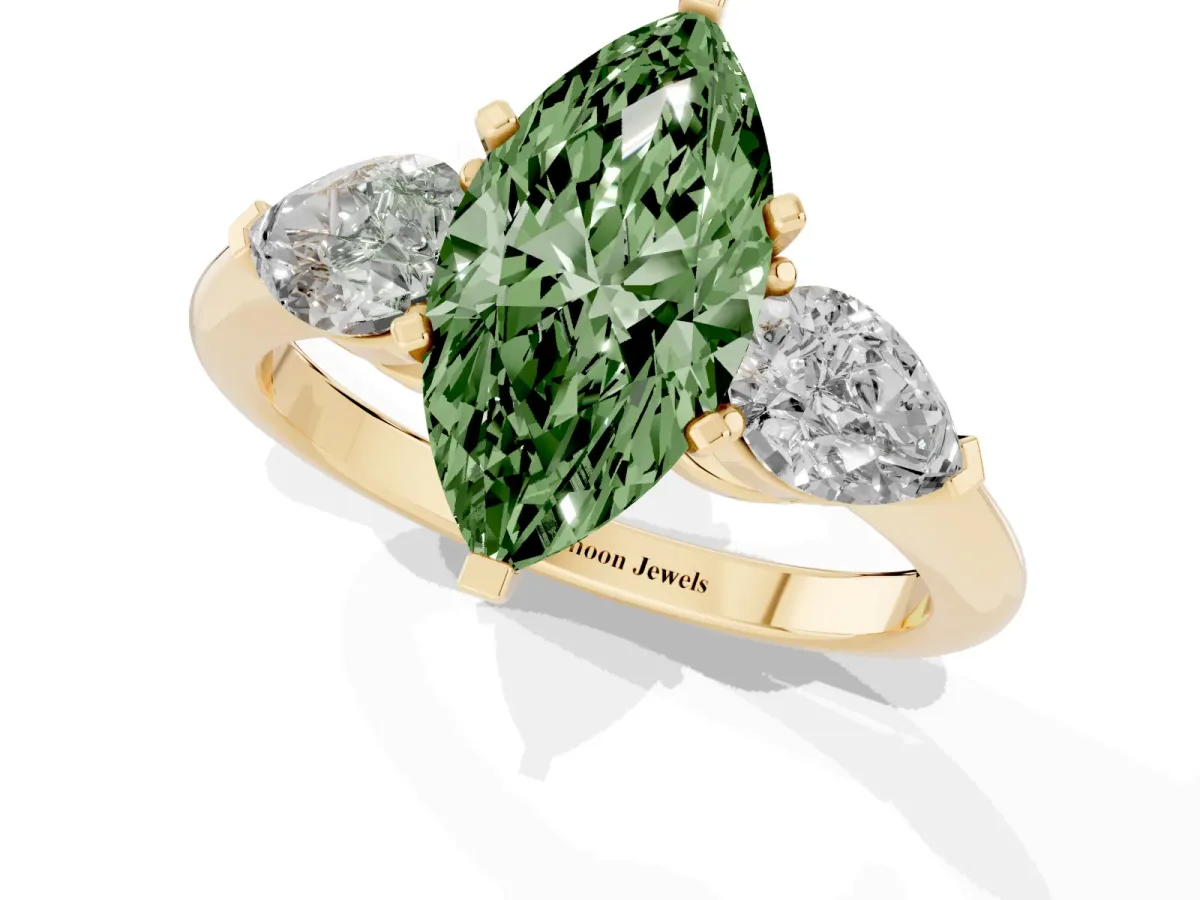Fancy Green Three-Stone Marquise Cut Diamond Ring with Pear Side Stones and Four-Prong Setting Yellow gold