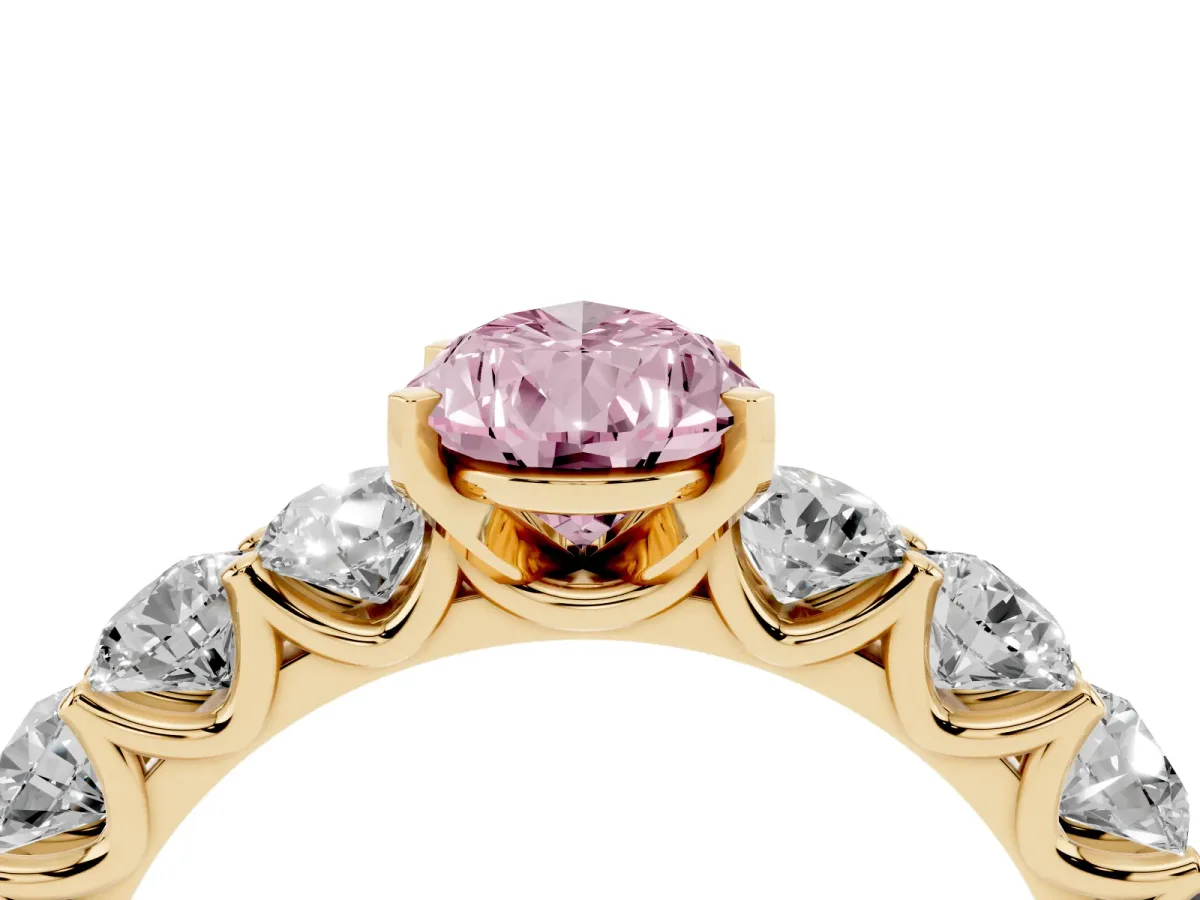 Fancy Pink Pear Cut Diamond Prong Setting with Side Stones on a Pave Band Yellow gold