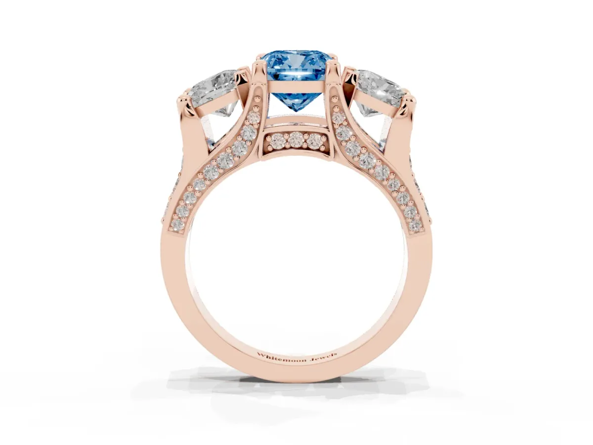 Fancy Blue Cushion Cut Diamond Three-Stone Ring with Channel Set Band and Four-Prong Setting Rose gold