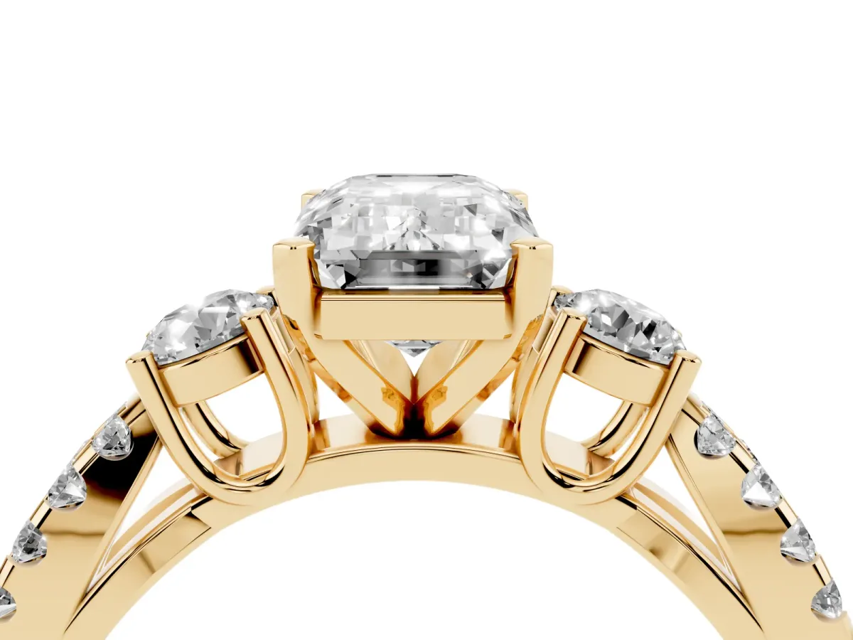 Emerald Cut Diamond Three-Stone Ring with Pavé Split Shank and Four-Prong Setting Yellow gold