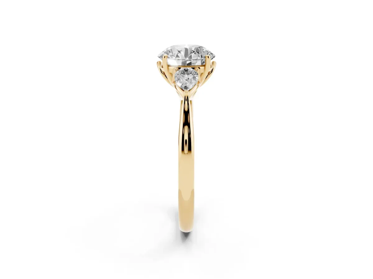 Three-Stone Round Cut Diamond Ring with Pear Side Stones in Four-Prong Setting Yellow gold