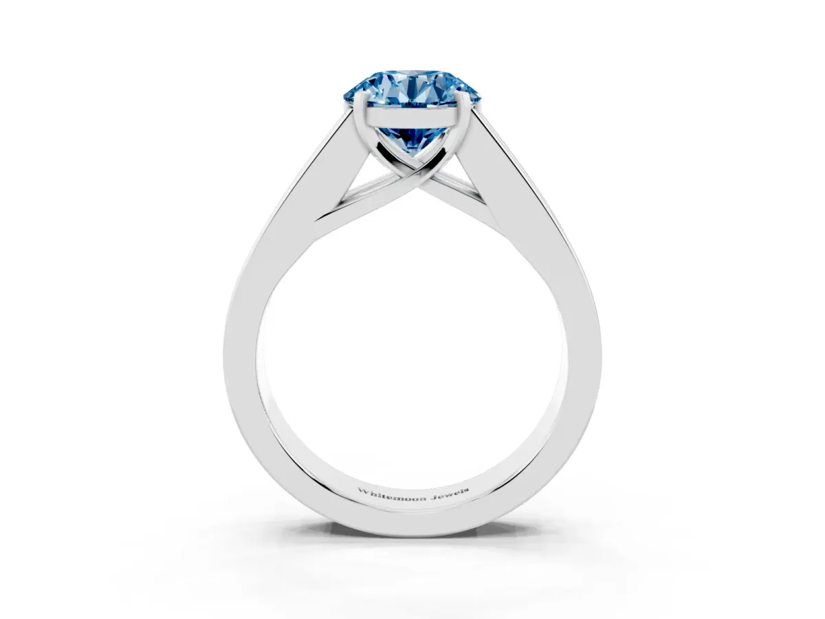 Fancy Blue Round Cut Cut Channel Set Solitaire Ring with Four-Prong Setting Silver