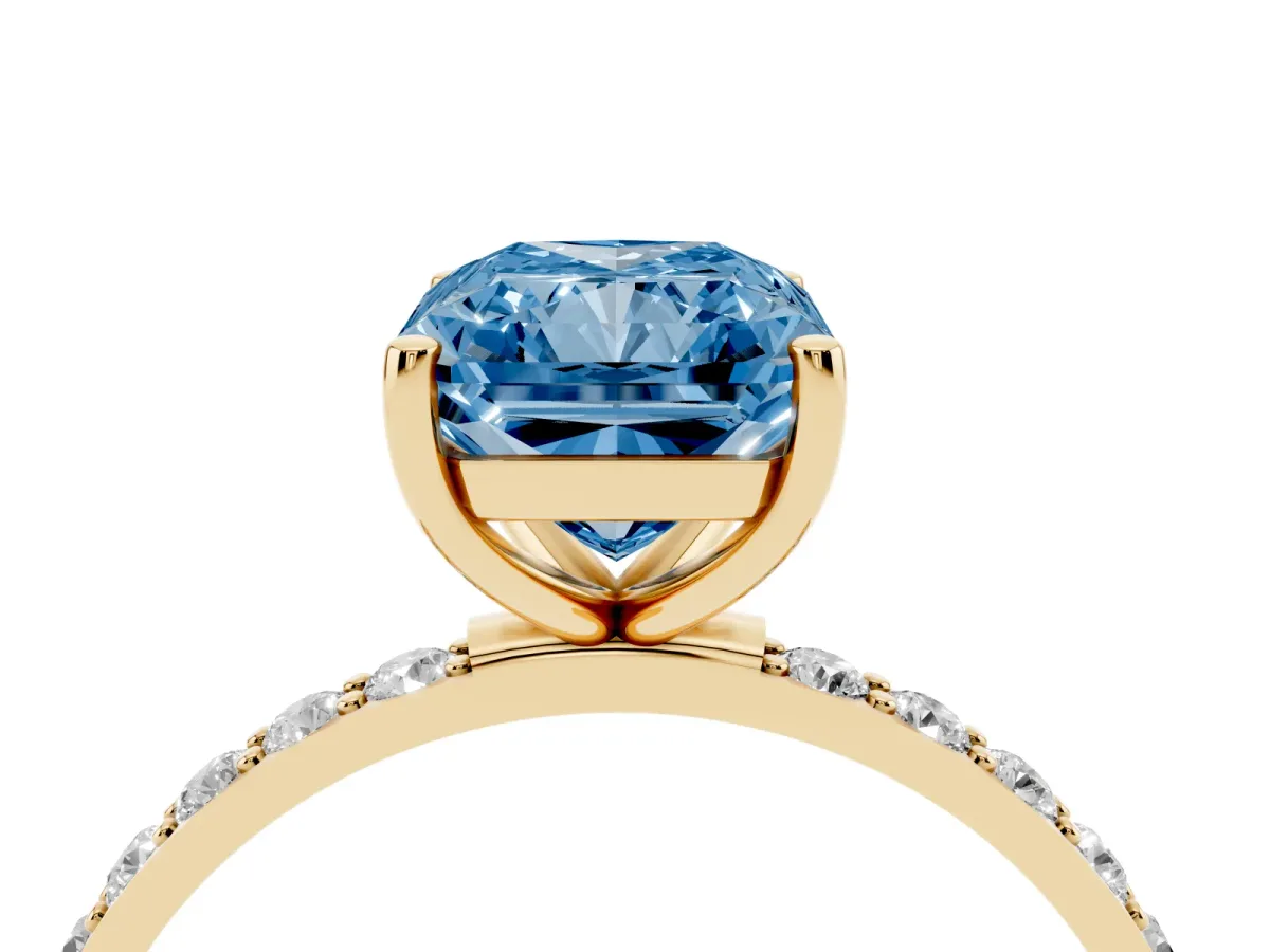 Fancy Blue Radiant Cut Diamond Solitaire Ring with Round Pavé Shoulders and Prong Setting Yellow gold
