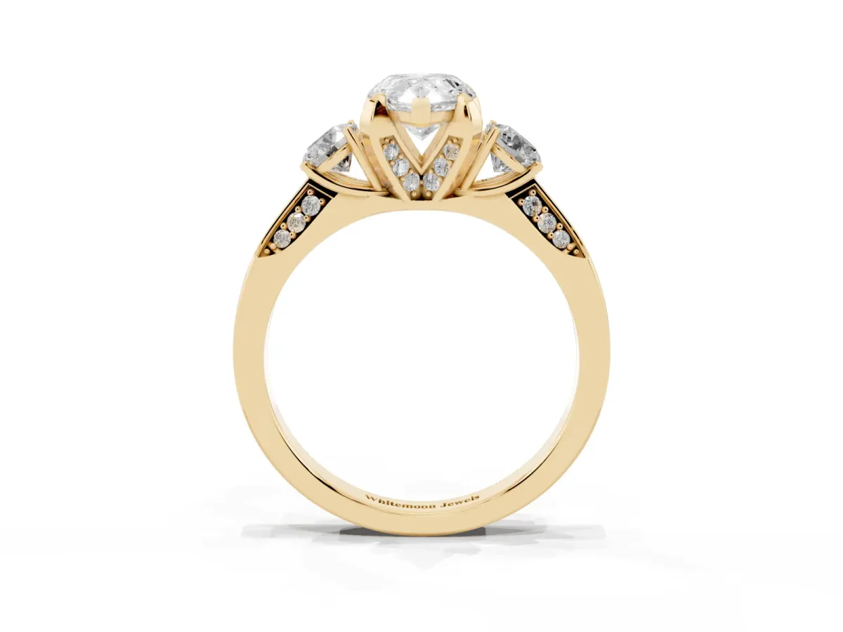 Pear Cut Brilliant Three-Stone Diamond Ring with Pavé Band and Four-Prong Setting Yellow gold