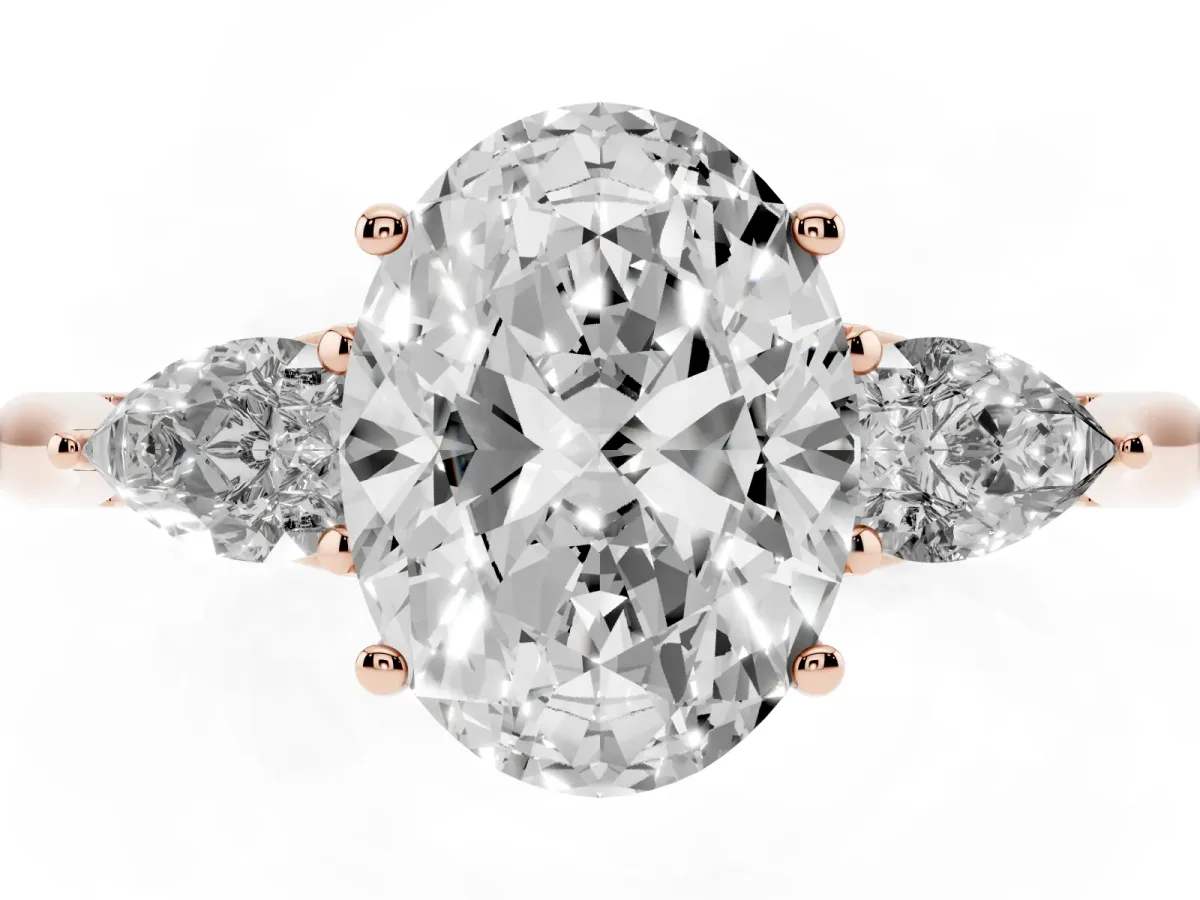 Three-Stone Oval Cut Diamond Ring with Pear Side Stones in Four-Prong Setting Rose gold
