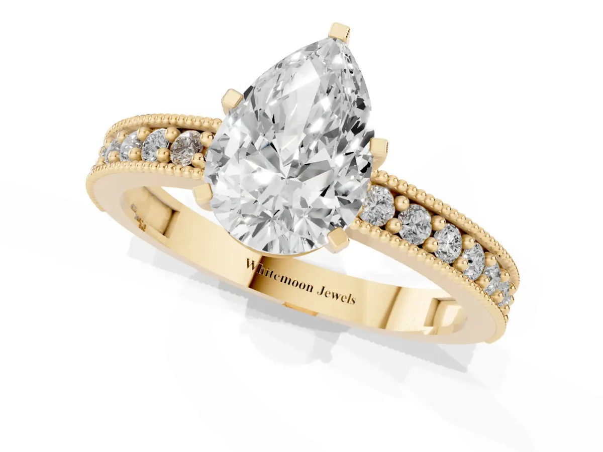 Pear Cut Diamond Milgrain Pavé Engagement Ring with Four-Prong Setting Yellow gold