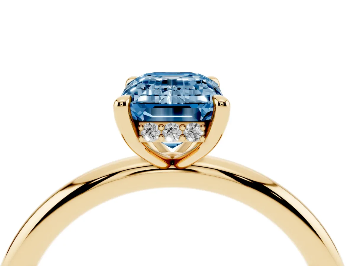 Fancy Blue Emerald Cut Diamond Solitaire Ring with Thin Band and Four-Prong Setting Yellow gold