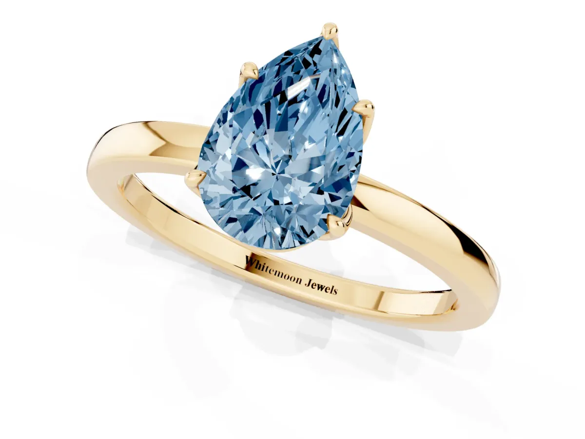 Fancy Blue Pear Cut Diamond Solitaire Ring with Thin Band and Prong Setting Yellow gold
