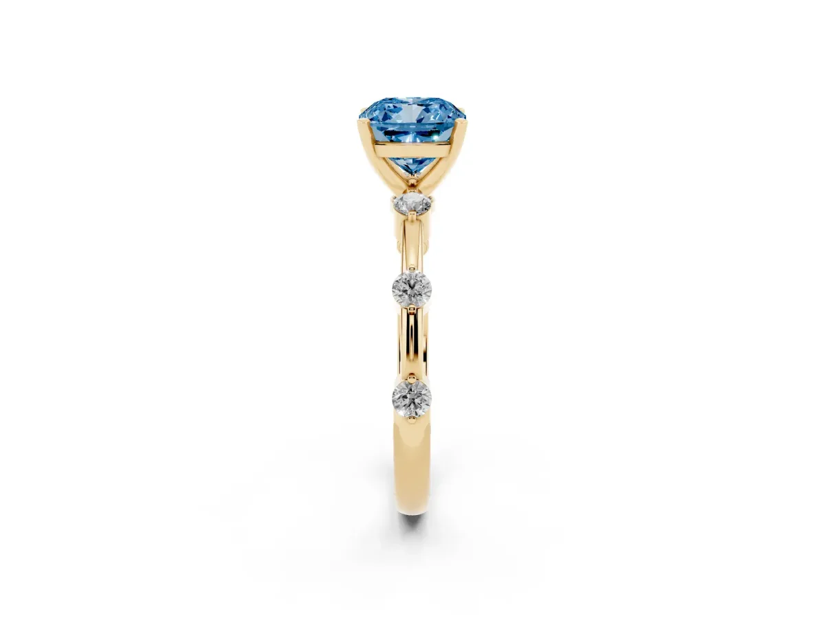 Fancy Blue Cushion Cut Solitaire Diamond Ring with Bezel Set Side Stones and Prong Setting Yellow gold