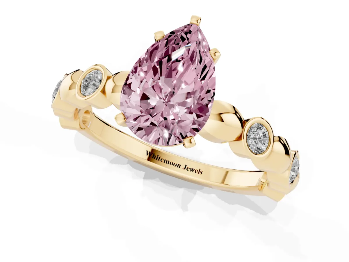 Fancy Pink Pear Cut Solitaire Bezel-Set Diamond Ring with Beaded Band and Four-Prong Setting Yellow gold