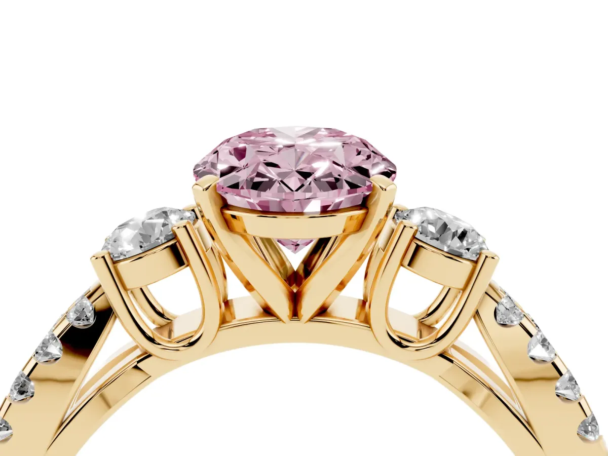 Fancy Pink Oval Cut Diamond Three-Stone Ring with Pavé Split Shank and Four-Prong Setting Yellow gold