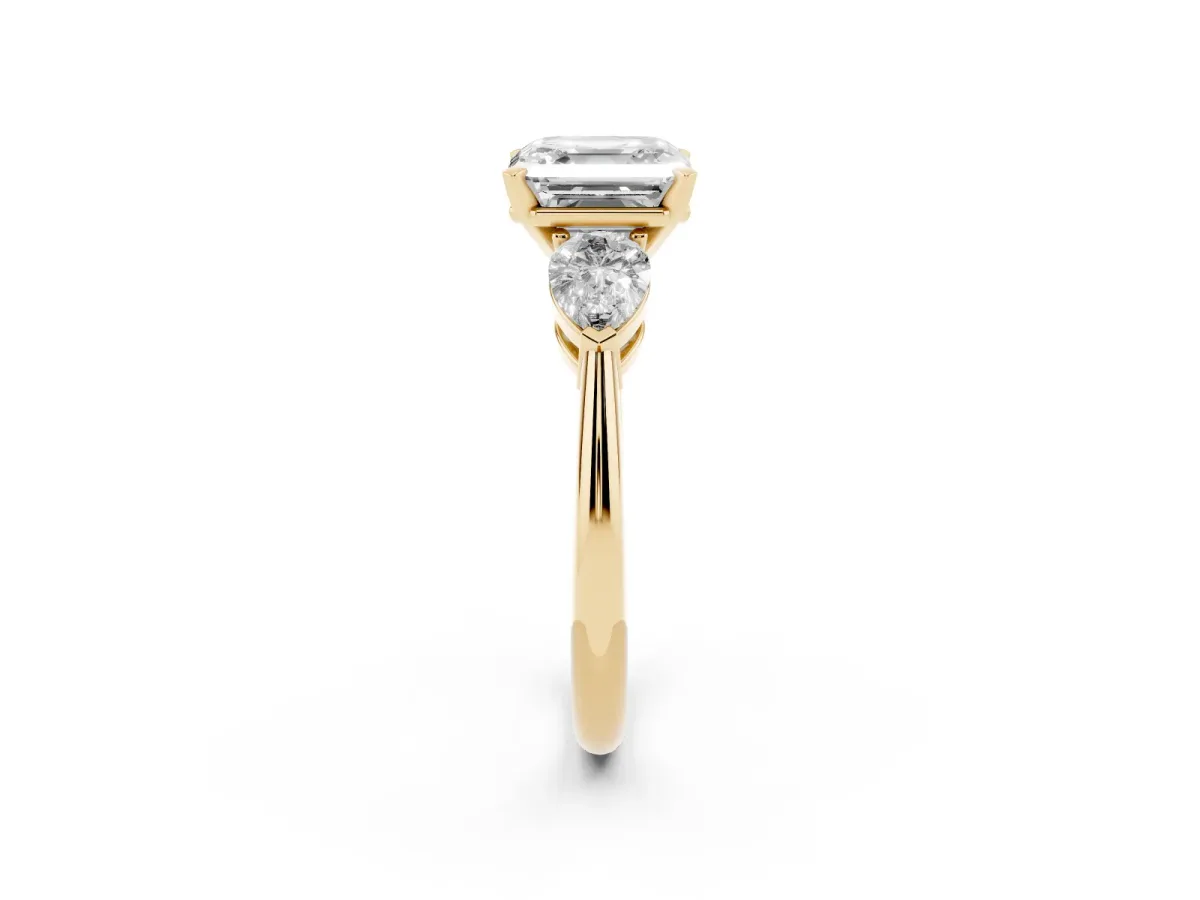 Three-Stone Asscher Cut Diamond Ring with Pear Side Stones and Four-Prong Setting Yellow gold