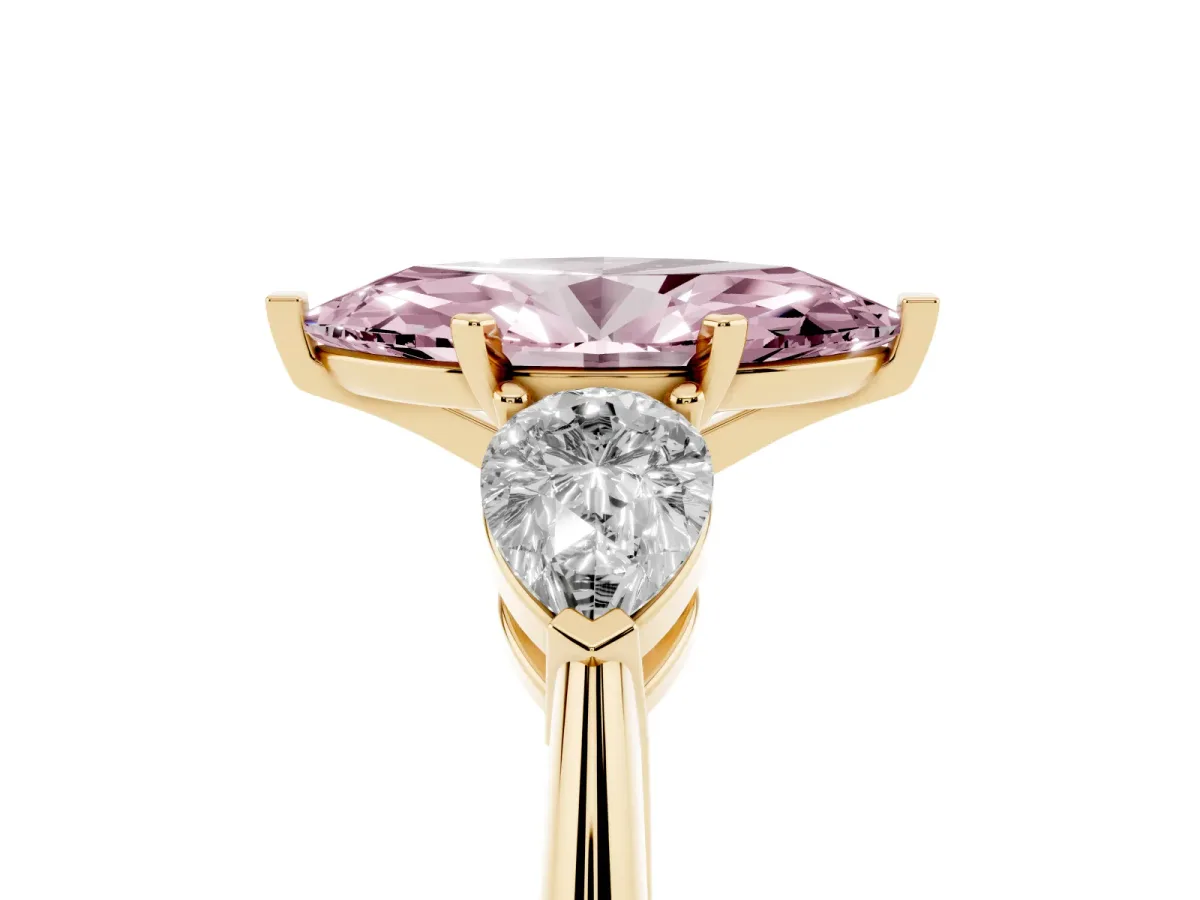Fancy Pink Three-Stone Marquise Cut Diamond Ring with Pear Side Stones and Four-Prong Setting Yellow gold