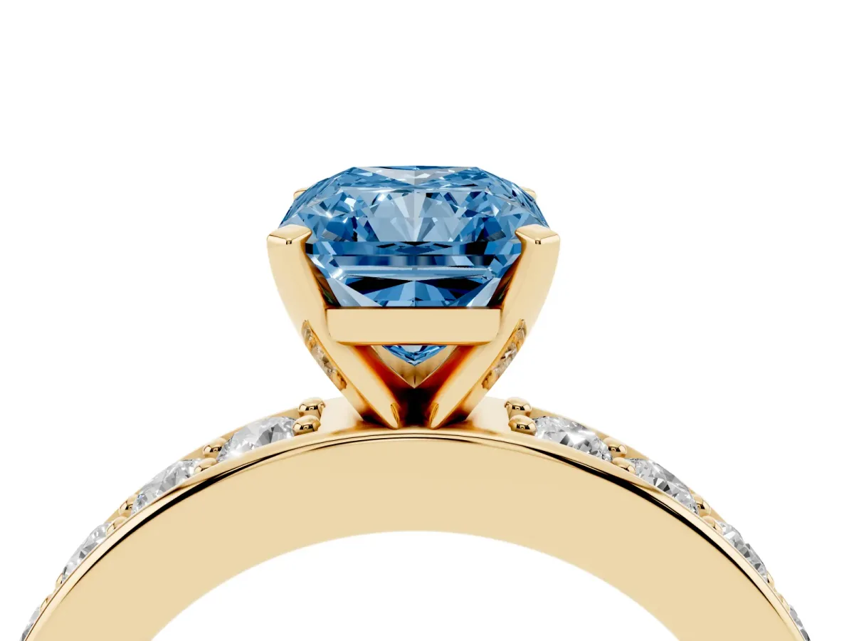 Fancy Blue Radiant Cut Diamond Engagement Ring with Channel Set Round Band and Prong Setting Yellow gold