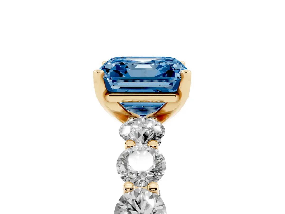 Fancy Blue Asscher Cut Diamond Prong Setting with Side Stones on a Pave Band Yellow gold