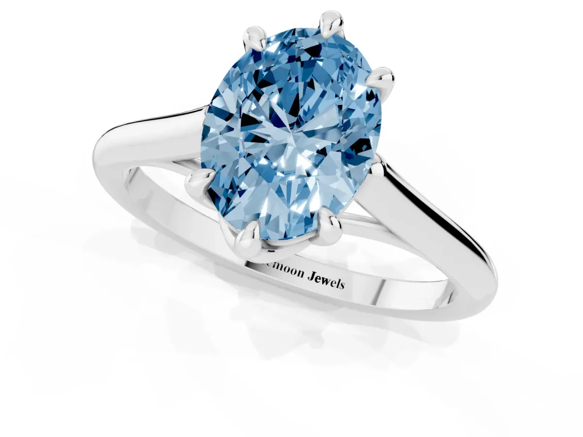 Fancy Blue Oval Cut Solitaire Engagement Ring with Six-Prong Setting and Classic Band Silver