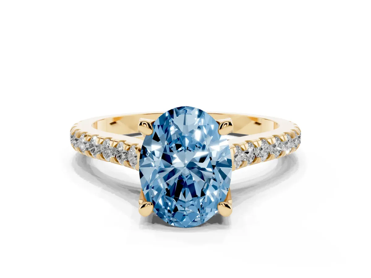 Fancy Blue Oval Cut Brilliant Diamond Solitaire with Pavé Band and Four-Prong Setting Yellow gold