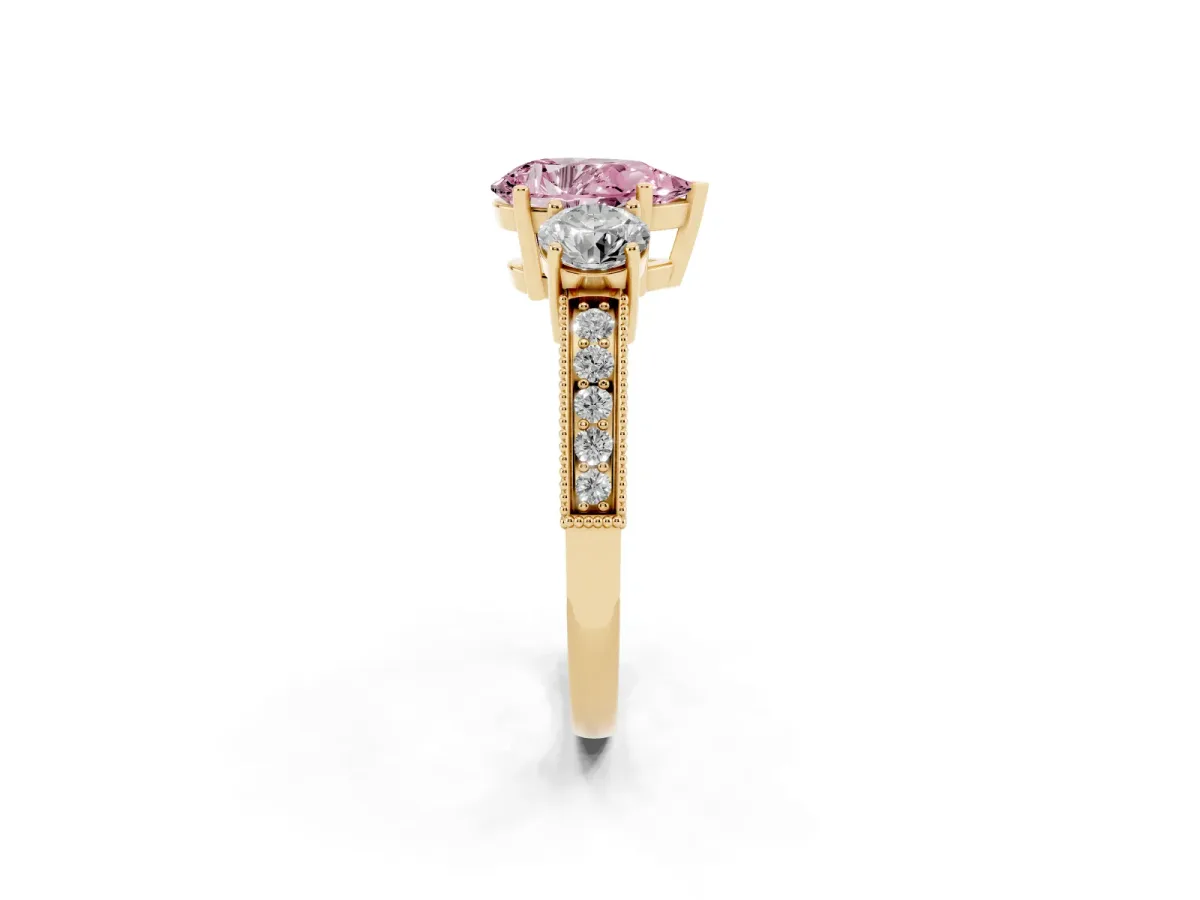 Fancy Pink Pear Cut Three-Stone Diamond Ring with Pavé Band and Four-Prong Setting Yellow gold