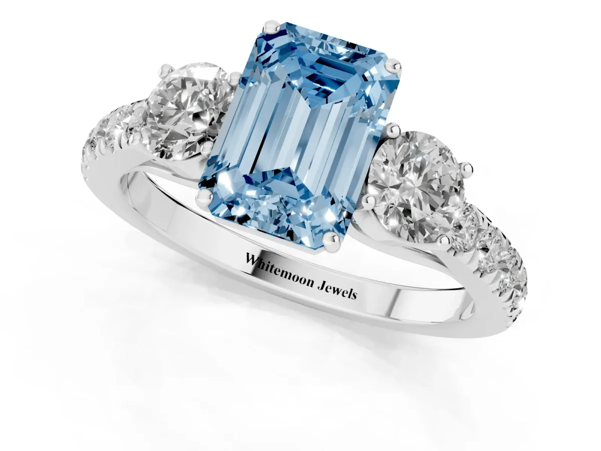 Fancy Blue Emerald Cut Cut Diamond Three-Stone Ring with Round Side Stones and Pavé Band Silver