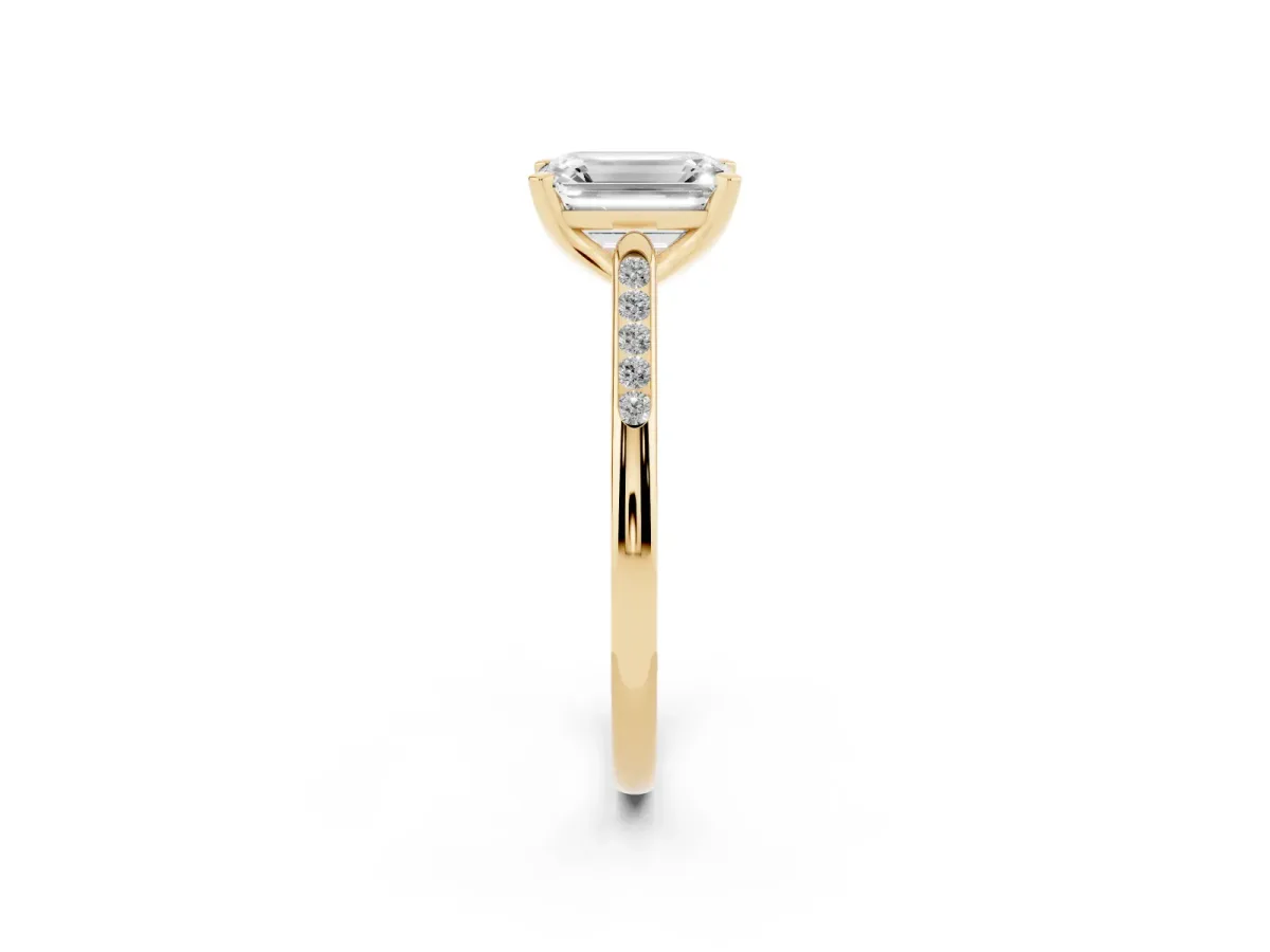 Emerald Cut Diamond Solitaire Ring with Channel Set Round Band and Prong Setting Yellow gold