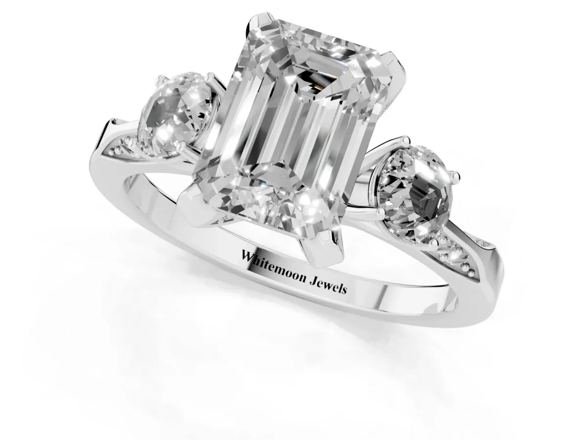 Emerald Cut Brilliant Three-Stone Diamond Ring with Pavé Band and Four-Prong Setting White gold