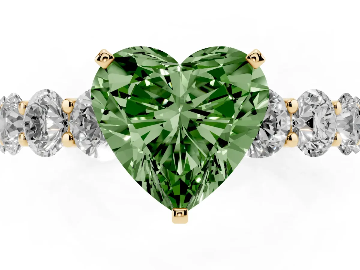 Fancy Green Heart Cut Diamond Prong Setting with Side Stones on a Pave Band Yellow gold