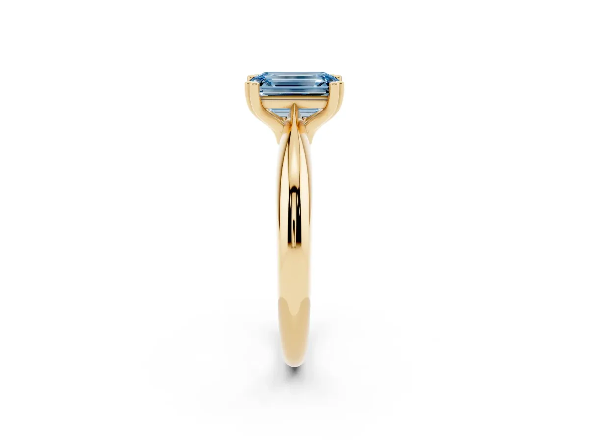Fancy Blue Emerald Cut Cut Solitaire Engagement Ring with Tapered Band and Four-Prong Setting Yellow gold