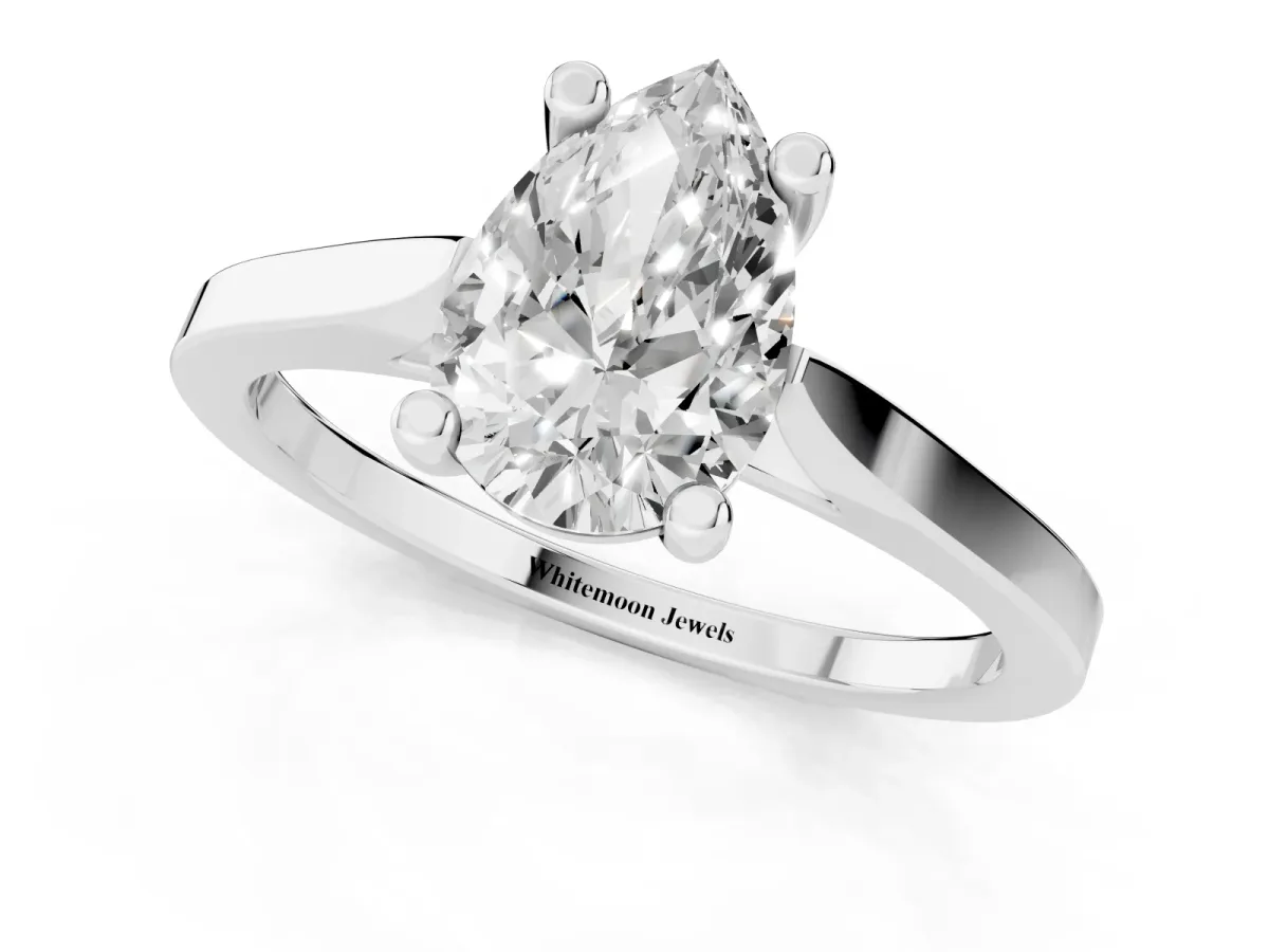 Pear Cut Solitaire Diamond Ring with Four-Prong Setting and Tapered Band Platinum