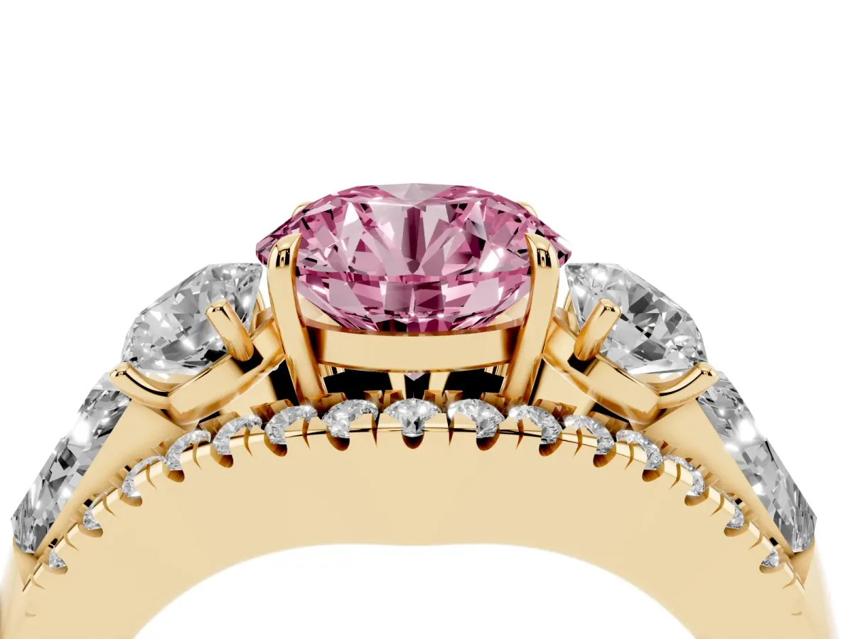 Fancy Pink Three-Stone Round Cut Diamond Engagement Ring with Pave Band and Prong Setting Yellow gold